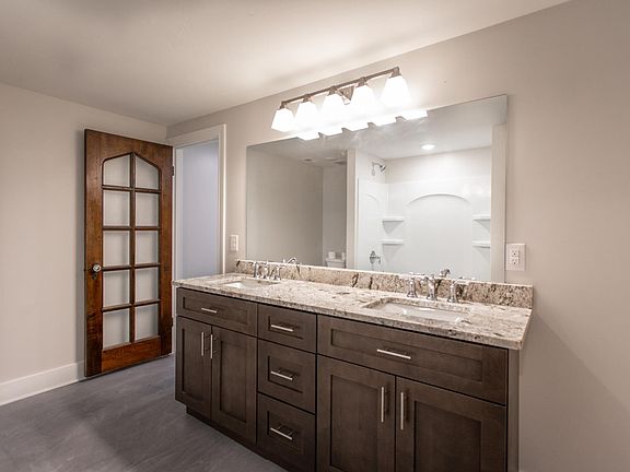 Double sink bathroom with original 1920's Tudor door with double access to the bedroom and main living space.