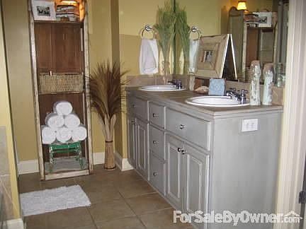 Master Bathroom : Smokey blue antiqued cabinets and whirpool tub make this masterbath an oasis.