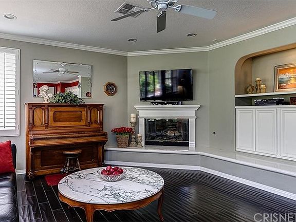 FAMILY ROOM: Raised wraparound hearth, built-ins