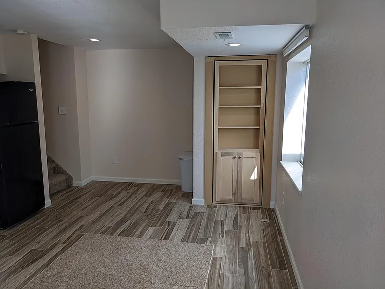 Large window and shelving in living area & kitchen