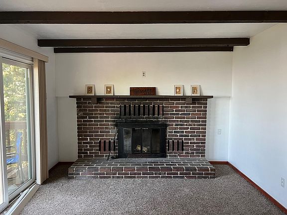 Main floor living room with brick fireplace.