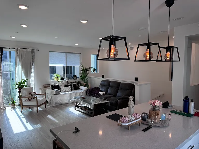 Living Room w/Pendant lights on kitchen countertop