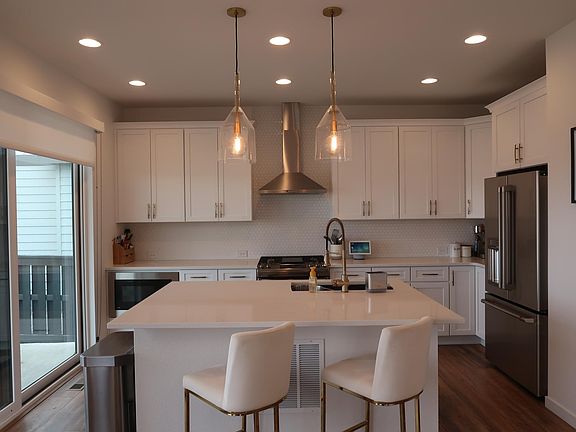 Kitchen with white cabinets and brass hardware