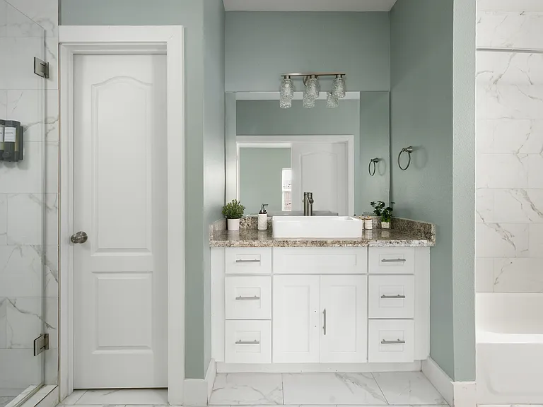 Modern vanity with vessel sink in the private ensuite bathroom.
