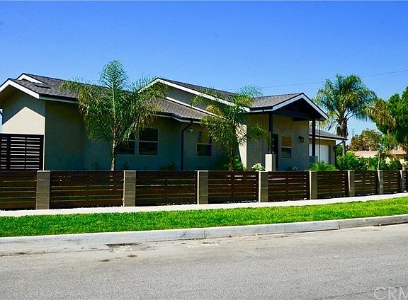 LOCATED ON A CIRCULAR FRONTAGE, THE GATED FRONT YARD ALLOWS FOR THE MOST EFFECTIVE USE OF THE LAND WHILE ADDING VISUAL INTEREST. NEW LANDSCAPING, TREES AND PRIVACY PLANTING ALREADY DONE.