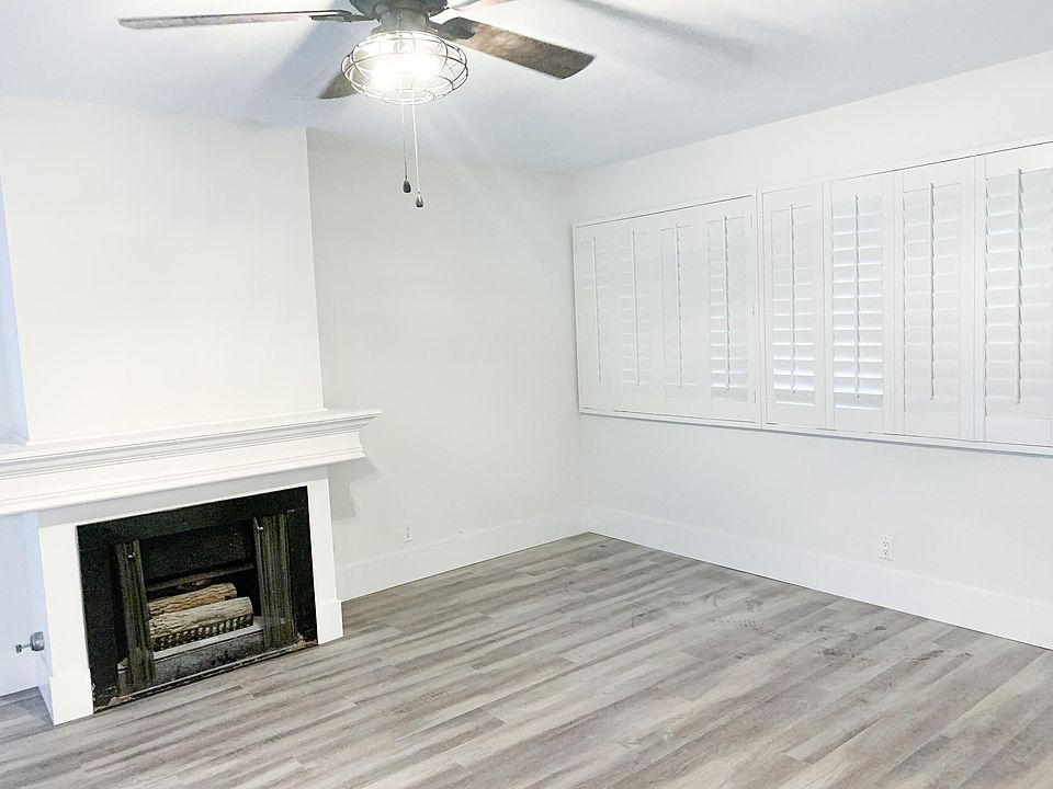 Living room with brand new fan, flooring, baseboards & paint