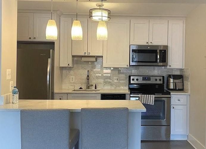 Custom-finished kitchen with stainless steel appliances and quartz countertops