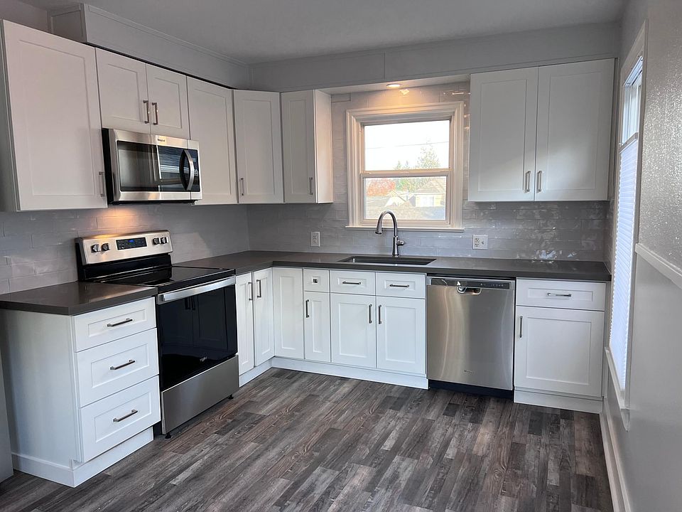 Completely remodeled!! New cabinets, quartz counters, tile backsplash, stainless steel appliances, luxury laminate flooring, blinds and paint. Blinds open top and bottom!!