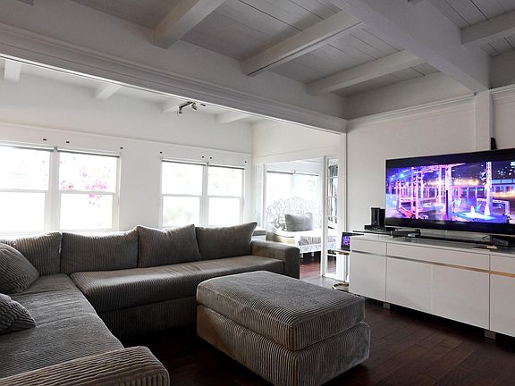 open living room with sun room with exit to yard