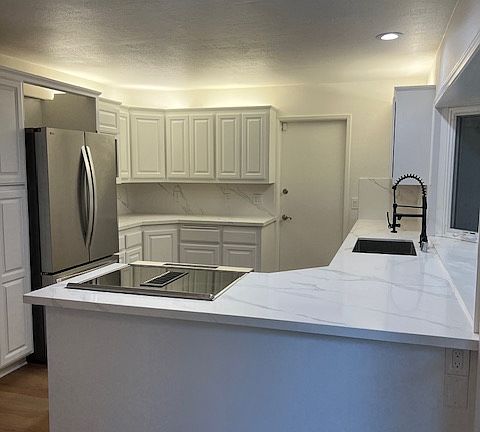 Spacious newly upgraded kitchen with quartz counters and new stainless appliances