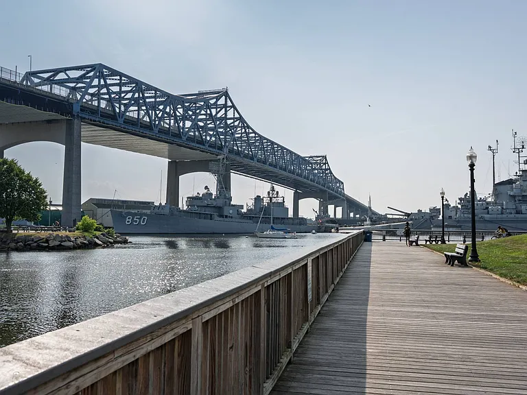 Battleship Cove tour historic naval ships and soak in river views about 12 minutes away.