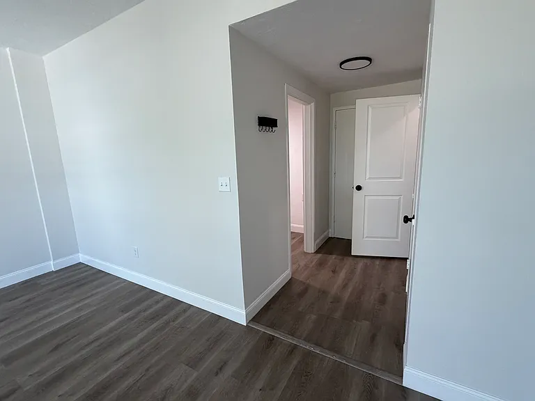 View from living space into walkway to kitchen and front door.