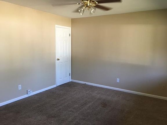 Living room with coat closet and ceiling fan