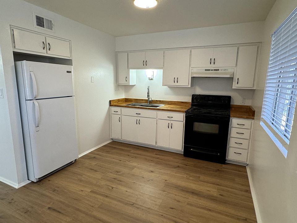 Spacious kitchen with custom-built countertops and restaurant-style sink.