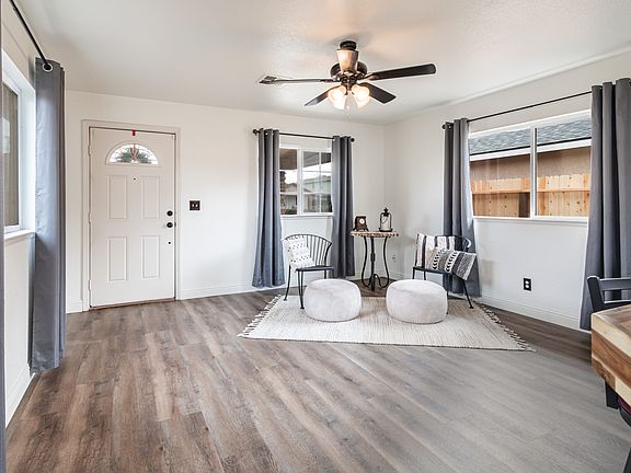 Living room with new blackout curtains, new flooring, and freshly painted.