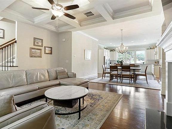 Open-concept main level with a view of the stairs.