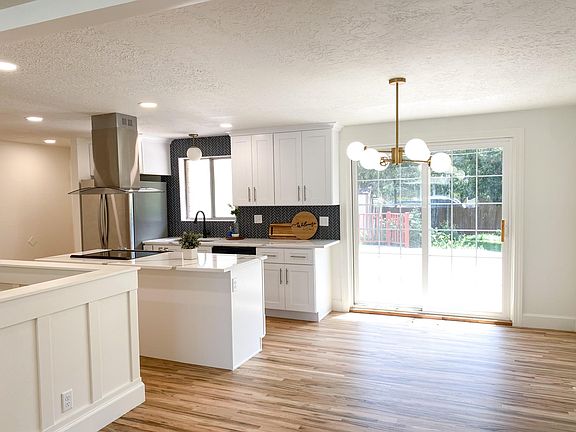 Open concept room to entertain family and deck extends off the same level of kitchen floor.
