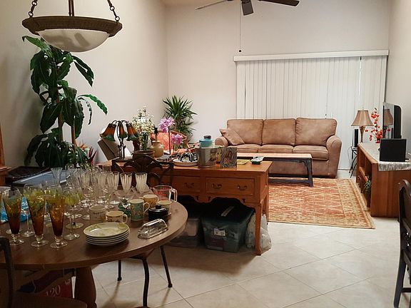 Dining and living area (packing has started). Sliding doors to screened porch are behind sofa. Master bedroom also has sliders to porch.