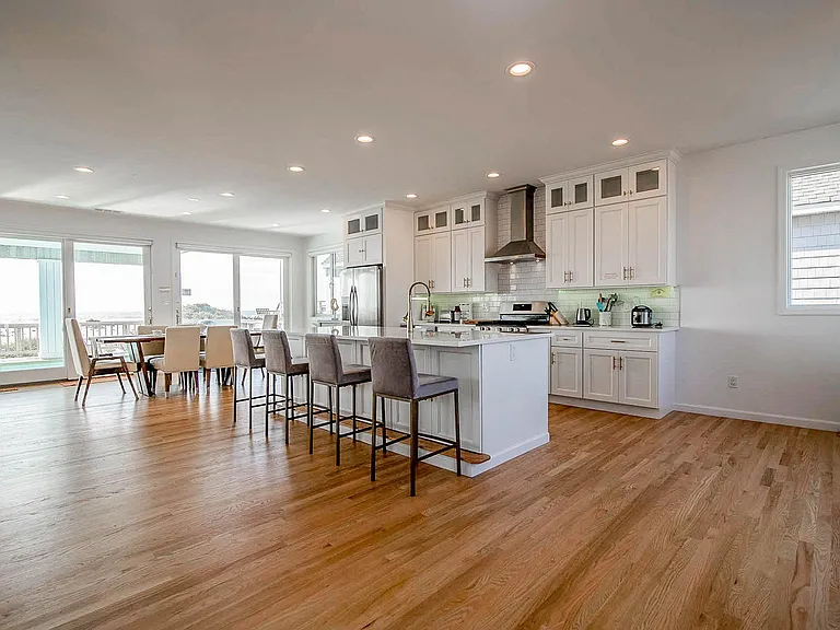 Gorgeous new light open kitchen with panoramic views of the ocean and bay Plenty of seating and beautiful wood floors. Extremely clean.