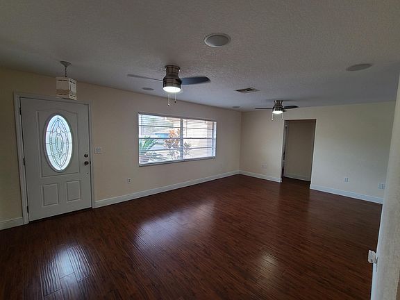Living room with new fans and faux wood blinds
