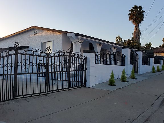 Sidewalk view front of home and secure gates.