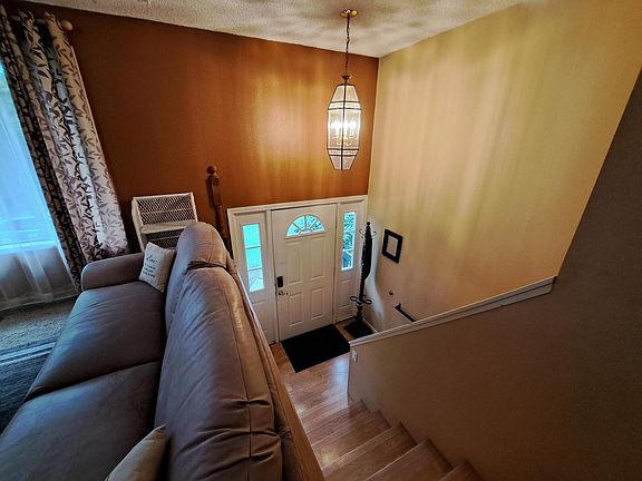 Looking down half flight to front door. Main living area is on the upper floor (kitchen, dining, living bath and 2 bedrooms). Downstairs has 2 bedrooms, bath/laundry.
