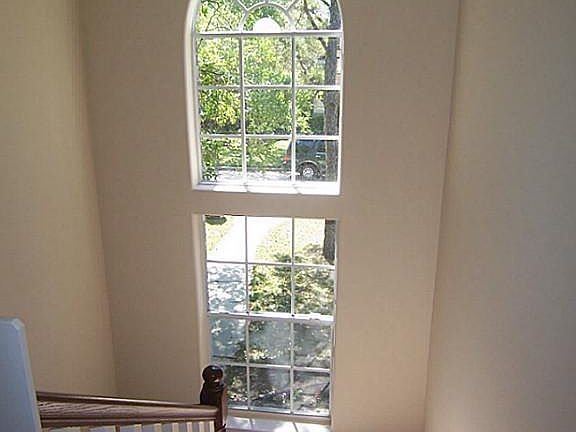 Bright, open spindle staircase with paladium window.