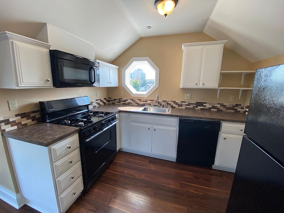 Kitchen with gas range, microwave and dishwasher.
