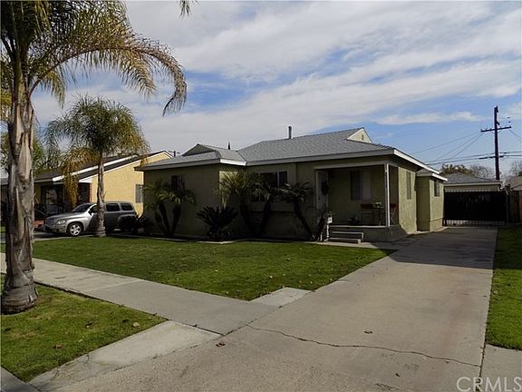 Long driveway leading to gated backyard and garage