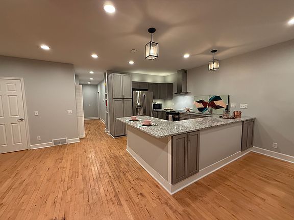 The kitchen features all new appliances, granite countertops, above and below cabinet lighting and ample storage.