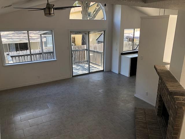 This large entertainment room with a working fireplace is around the corner from the kitchen. Versatile? Yes! A TV room, a party hangout area with a sliding door that opens out into a covered patio area for those quiet moments with a special friend.