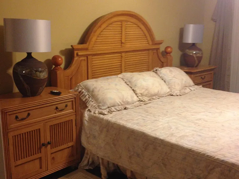 master bedroom with king bed set, two night stands and two dressers