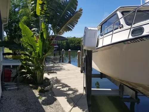 boat lift with new cover and dock - 3954 Dewberry Ln