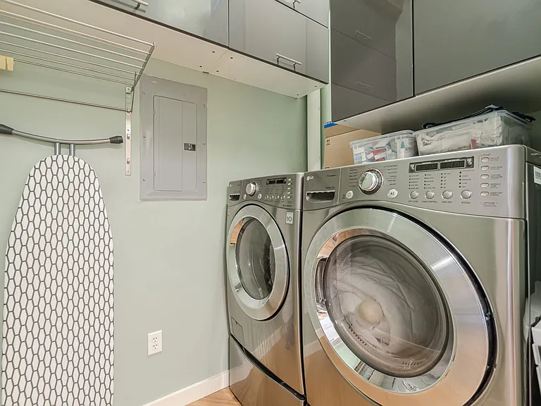 Laundry room with ample overhead storage space