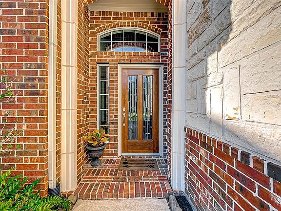The exterior features brick, stone and cast stone details. All four sides of the home have brick. There are gutters on both the front and back of home.