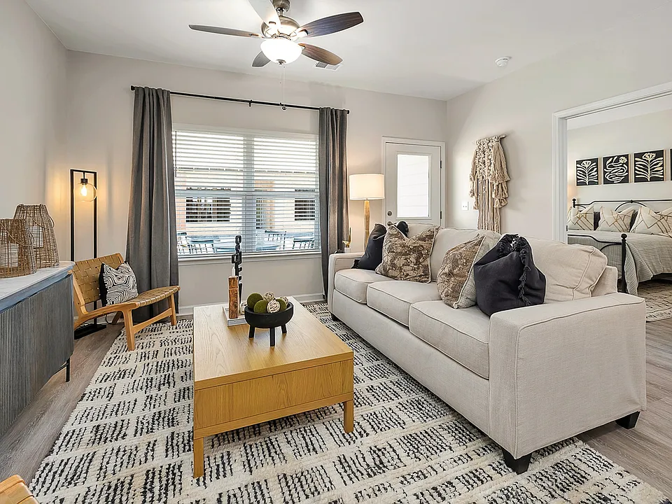 Inviting Living Room with ceiling fan and natural light