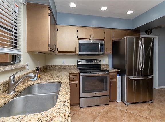 Kitchen with stainless look appliances.