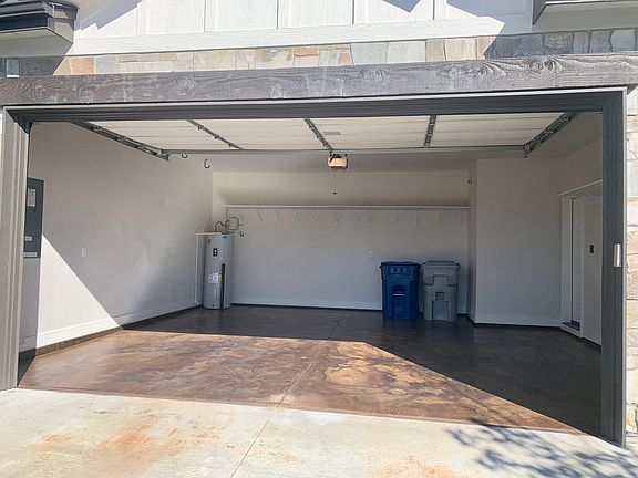 2 car garage with a couple shelves