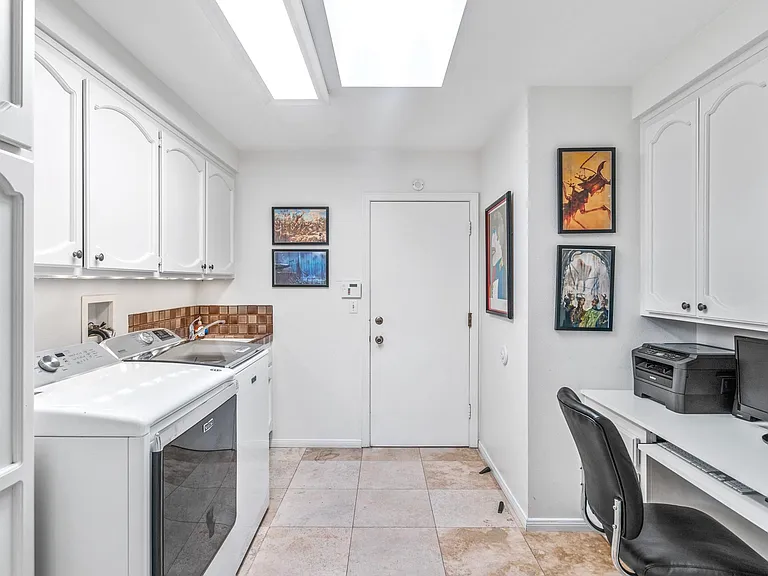 Laundry area with designated work space for your laptop and office chair.