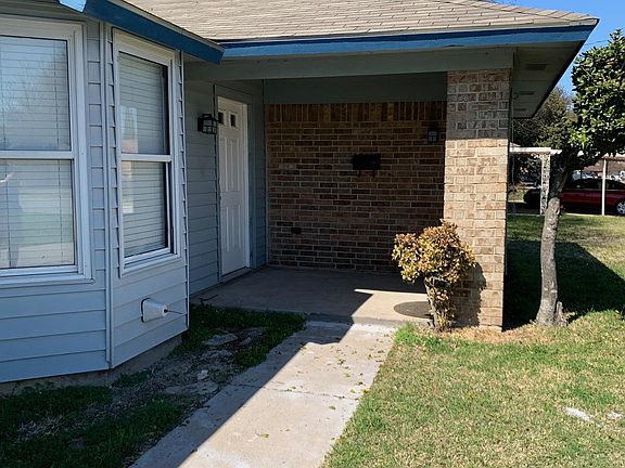 Welcoming, covered front porch with built-in flower box.