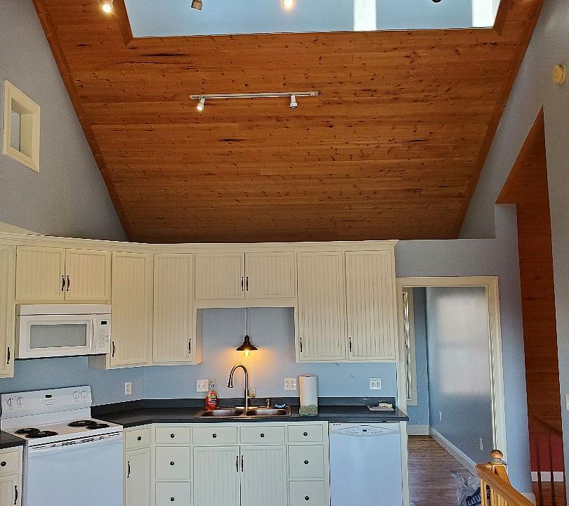 Kitchen area with open ceiling and cupola.