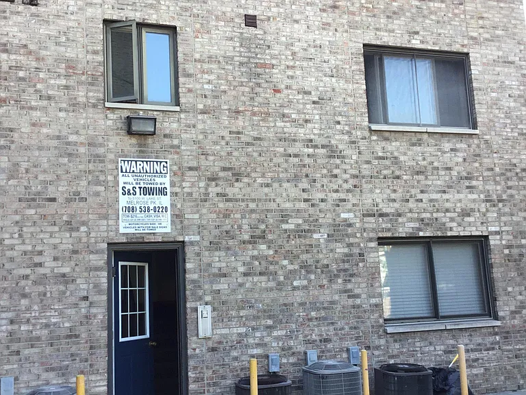 Paved off street parking in back, with intercom secured entrance