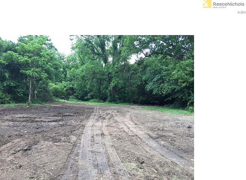 Level lot in heart of Shawnee is surrounded by trees on 3 sides.   You can have a home with a shop or outbuilding on this home site.