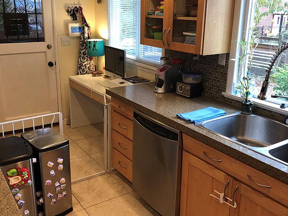 Kitchen entry area. Wood w/ Glass cabinets, granite counters, tile flooring, Stainless steel appliances, large dual sinks with single handle pull-down sprayer faucet.