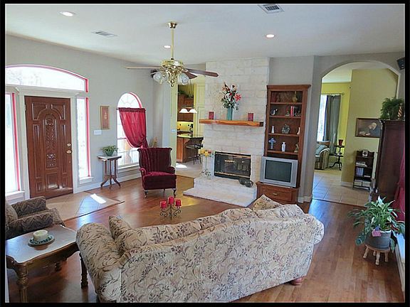 Living room features arched doorways, double sided fireplace shared with the country kitchen. Beautiful hardwood floors!