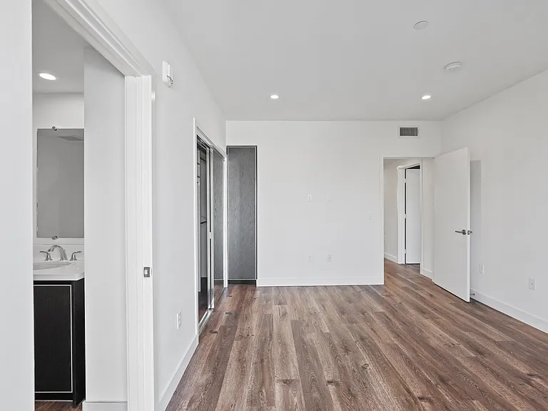 Bedroom with Closet, Vinyl Flooring, Recessed Lighting, and Bathroom
