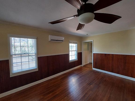 Living room looking into kitchen door. Mini-split air/heat on wall.