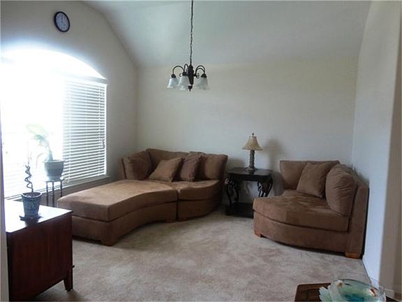 Formal dining/play room/TV room with arch window
