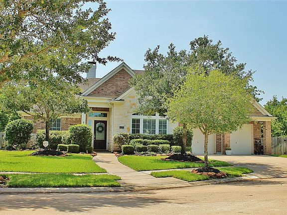 This home is all brick and stone for easy maintenance and the 3 car tandem garage with a covered extension in the front provides plenty of storage for all of your tools, cars and toys!