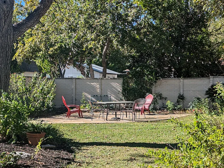 Garden with lights, grill, and pecan trees. There's also a large rooftop deck.